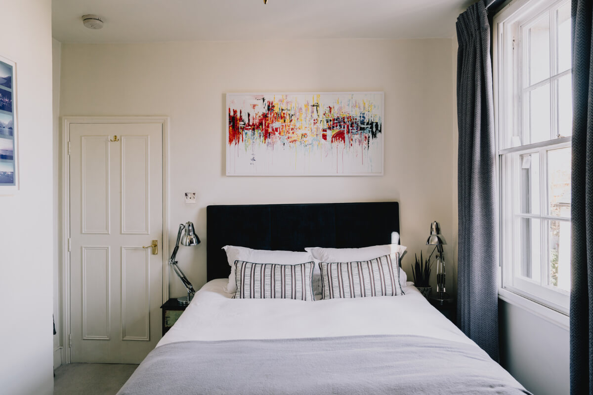 Countryside Charm in a London Apartment in a Former Ale House 17 bedroom with dark blue headboard