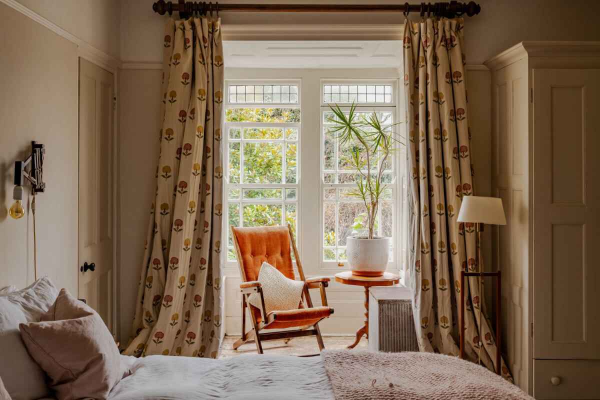 A Strong Color Palette in a Unique Country House in Cornwall 14 bedroom with floral curtains
