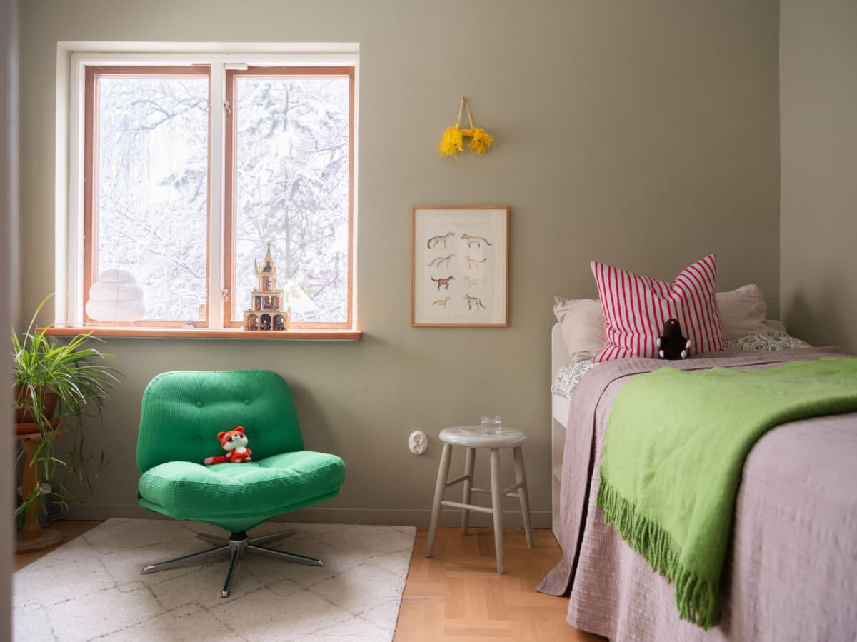 A Beautiful Midcentury Family Home South of Stockholm 26 bedroom with gray-green walls and green swivel chair