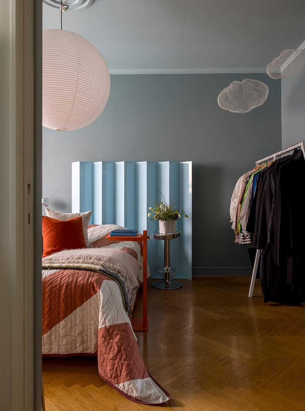 An Interior Designer's Moody Apartment with Period Features 12 bedroom with pastel blue headboard