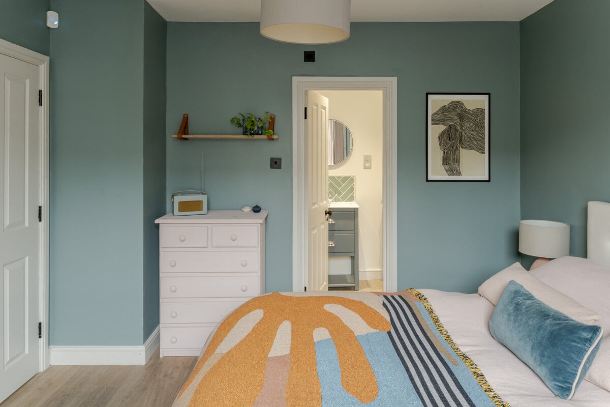 A Beautiful Extended Victorian Family Home in London 16 blue-gray bedroom with colorful throw