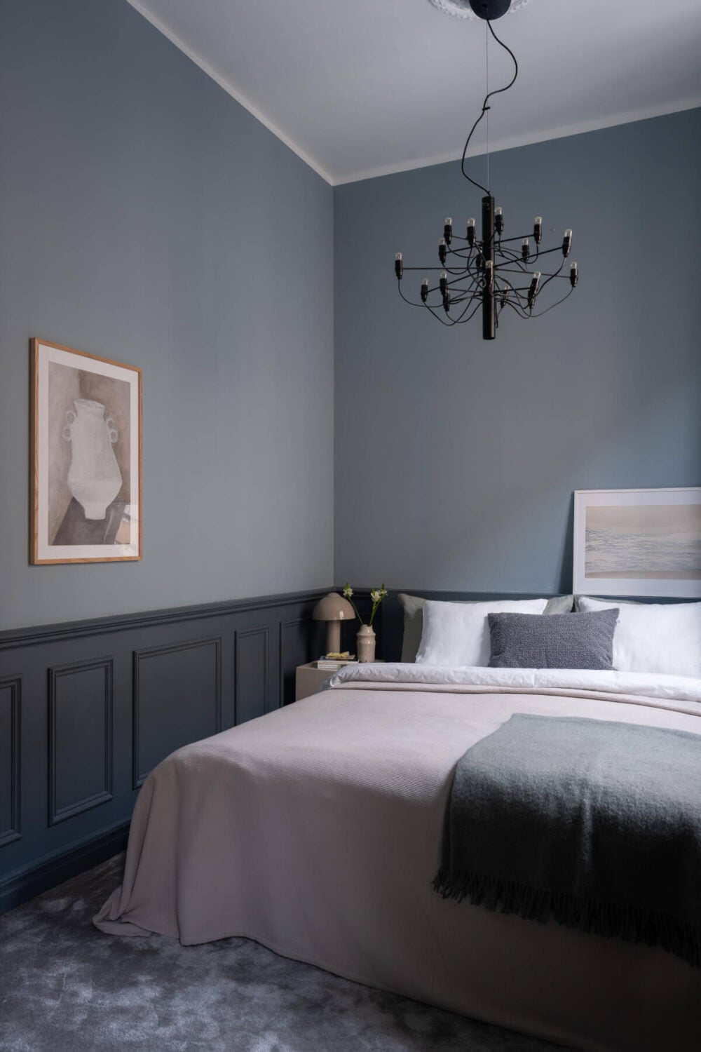 A Moody Color Palette in a Stylish One-Bedroom Apartment in Stockholm 10 blue-gray bedroom with dark carpet