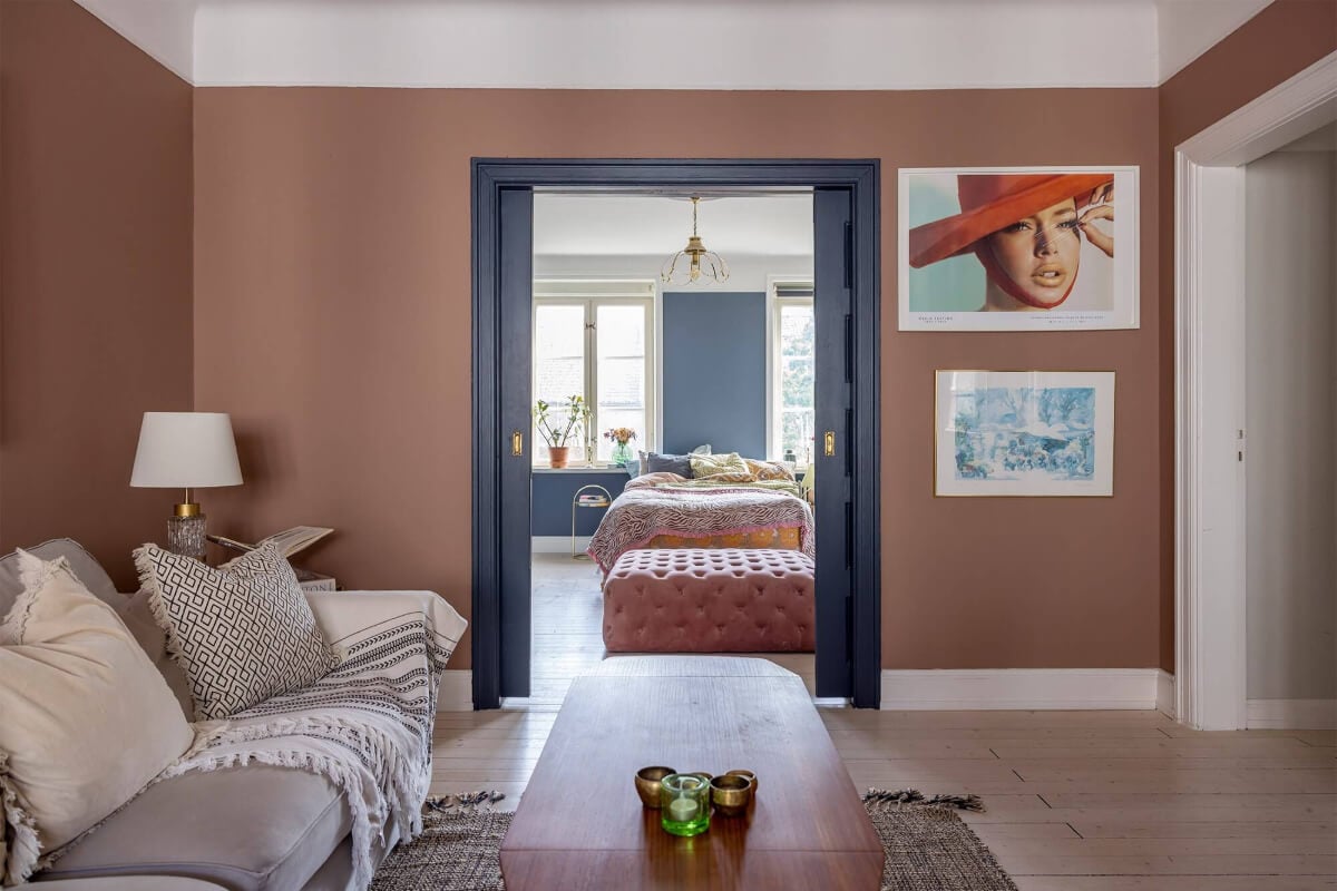 A Spacious Nordic Apartment with a Wonderful Color Palette 9 blue painted sliding doors dividing living and bedroom nordroom