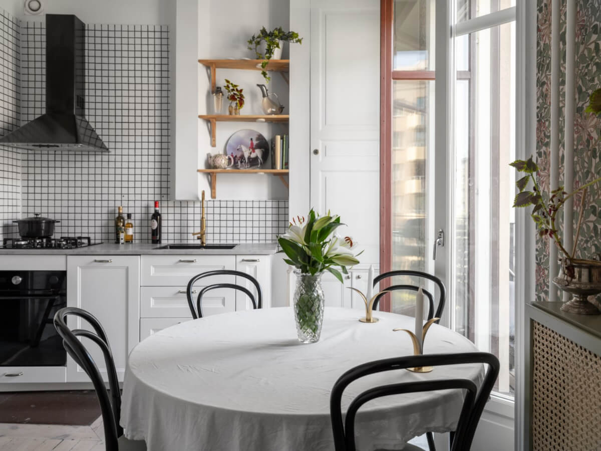 A Classic Studio Apartment with an Industrial Glass Room Divider 14 classic kitchen white cabinet and round table A Classic Studio Apartment with an Industrial Glass Room Divider