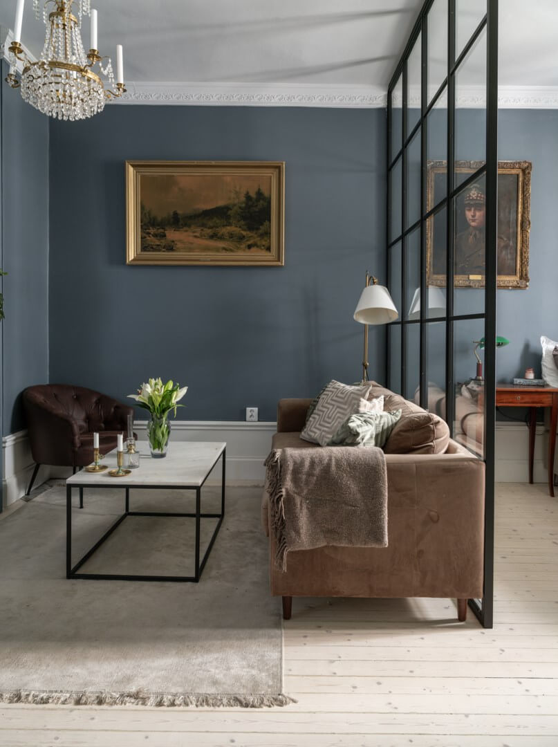 A Classic Studio Apartment with an Industrial Glass Room Divider 4 classy dark blue studio apartment seating area nordroom A Classic Studio Apartment with an Industrial Glass Room Divider