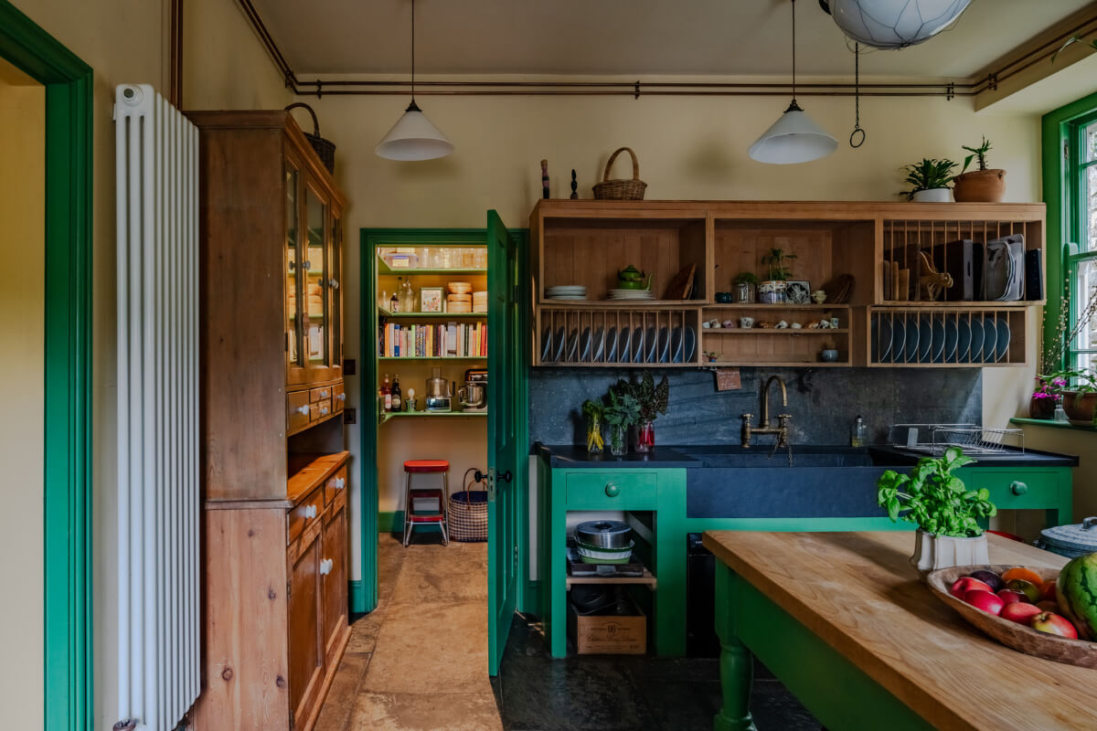 A Strong Color Palette in a Unique Country House in Cornwall 2 colorful kitchen with green cupboards and open cabinets