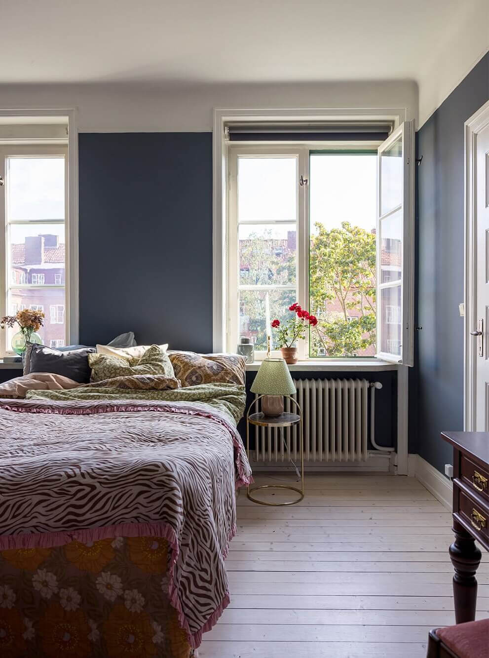 A Spacious Nordic Apartment with a Wonderful Color Palette 10 dark blue bedroom with wooden floor