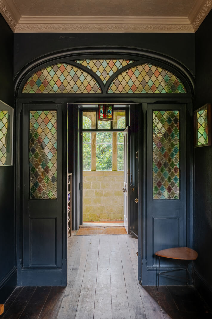 A Strong Color Palette in a Unique Country House in Cornwall 22 dark blue woodwork and stained glass