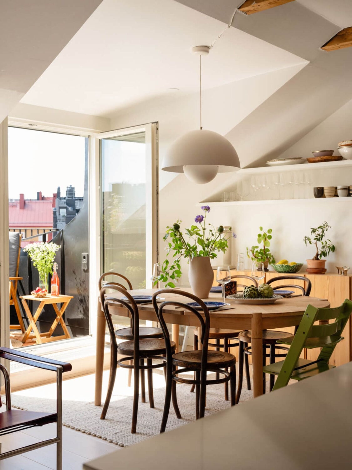 A Charming Light-Filled Attic Apartment with a Dark Oak Kitchen 3 dining area with balcony