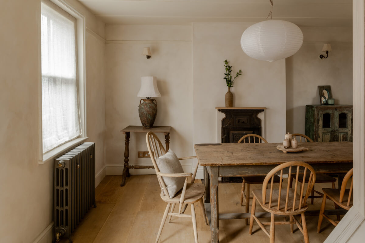 A Light Rustic Farmhouse-Style in an English Cottage 8 dining room with rustic table and plaster walls nordroom