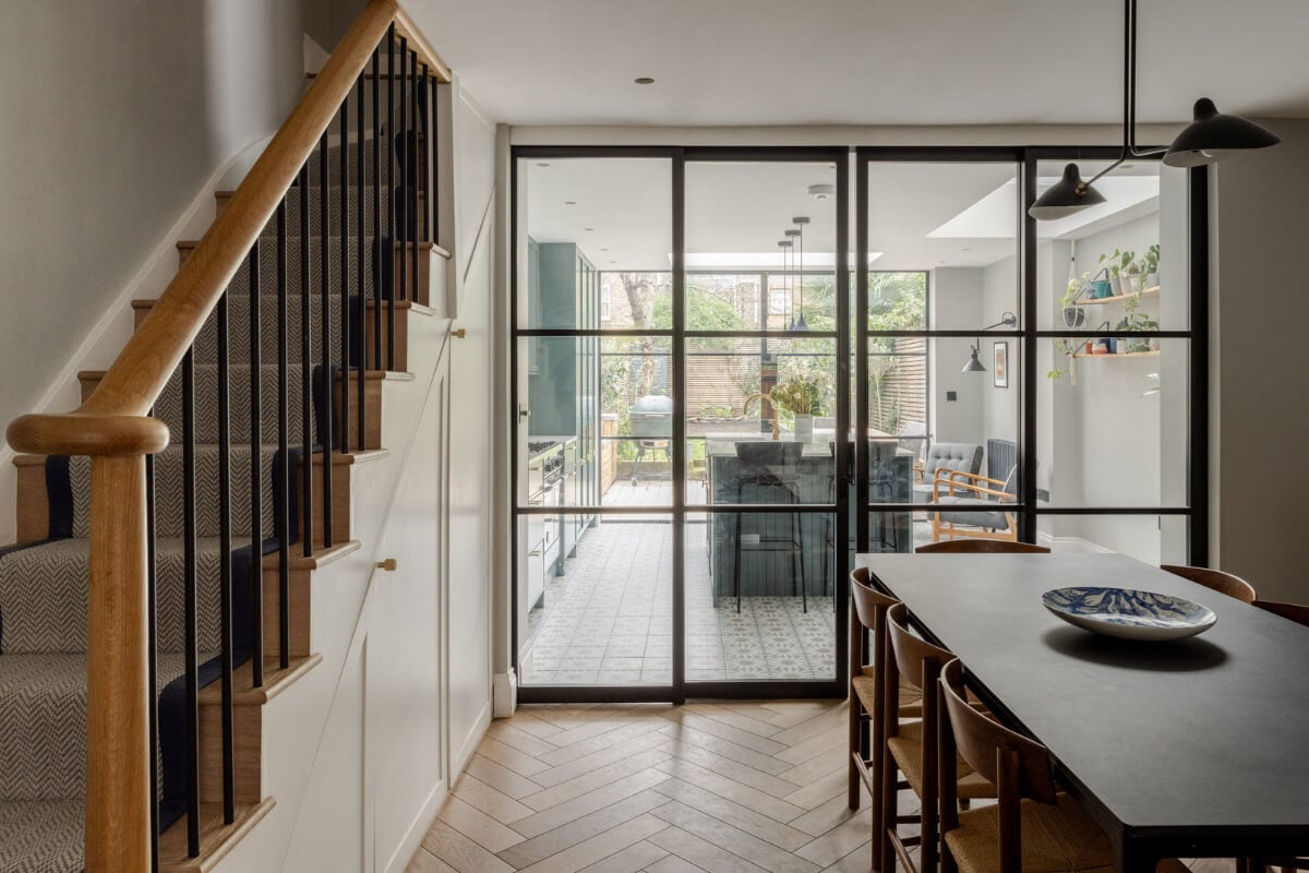 A Beautiful Extended Victorian Family Home in London 3 dining room with steel glass doors to the kitchen nordroom