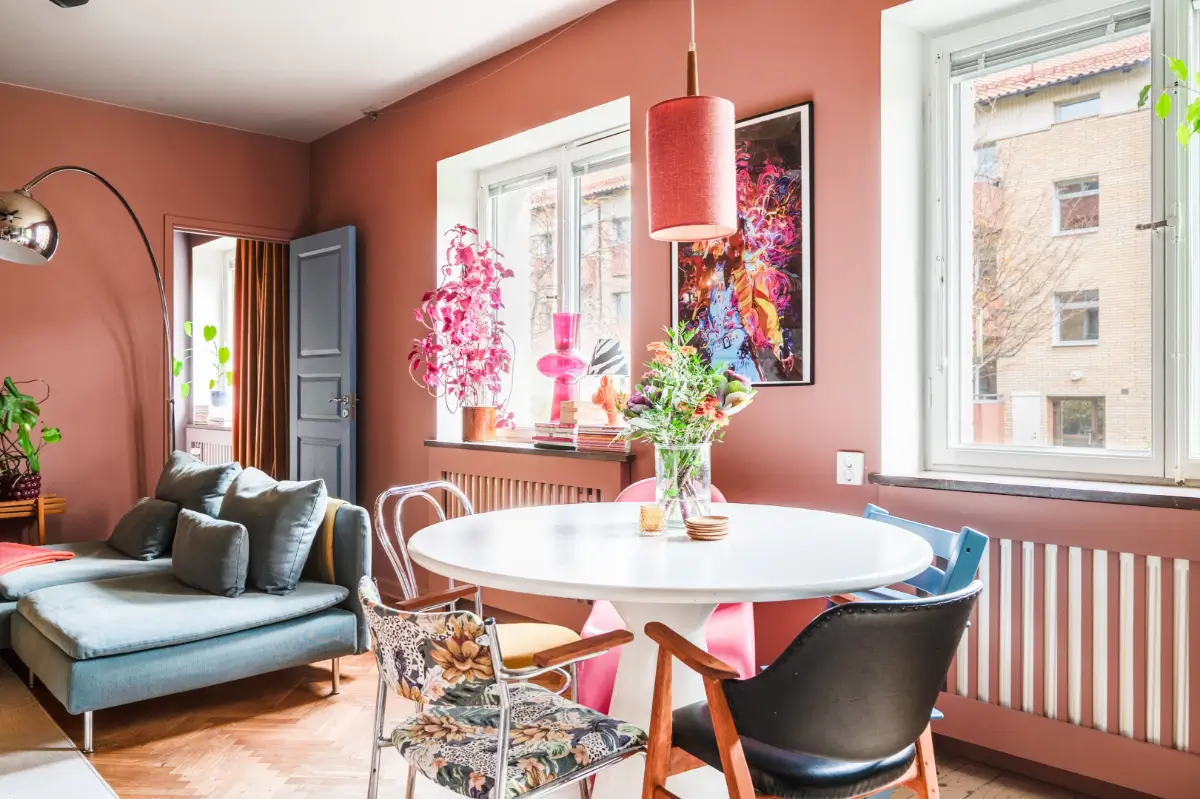 A Vibrant, Colorful Midcentury Apartment in Malmö 5 earthy pink living room with white round table