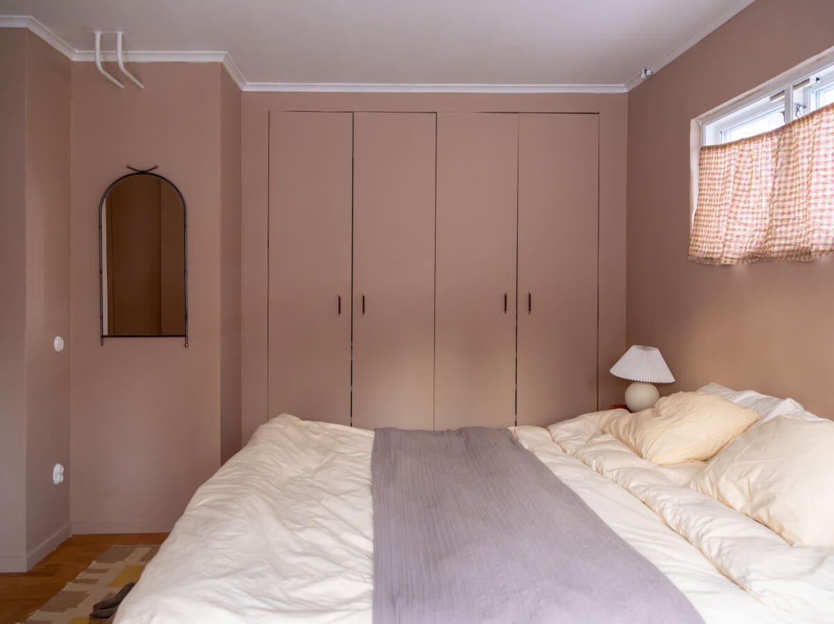 A Beautiful Midcentury Family Home South of Stockholm 17 earthy pink walls bedroom built-in wardrobes