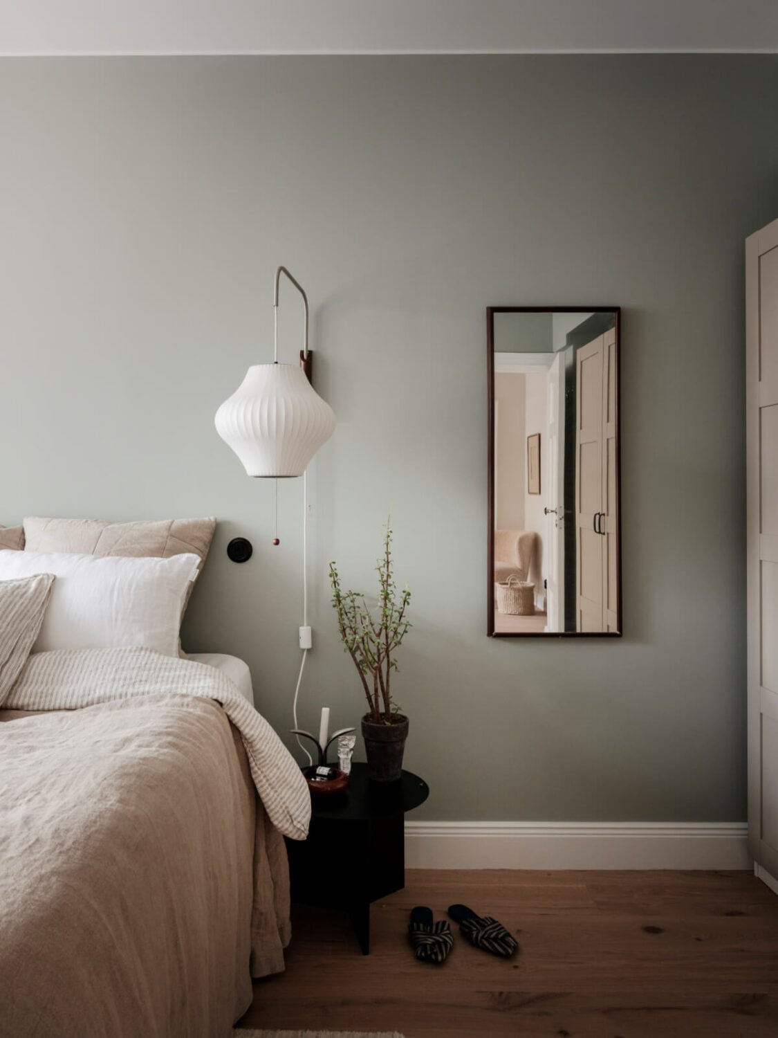 A Calm and Contemporary Apartment in a Former Office Space 17 gray bedroom with mirror and large wall lamp