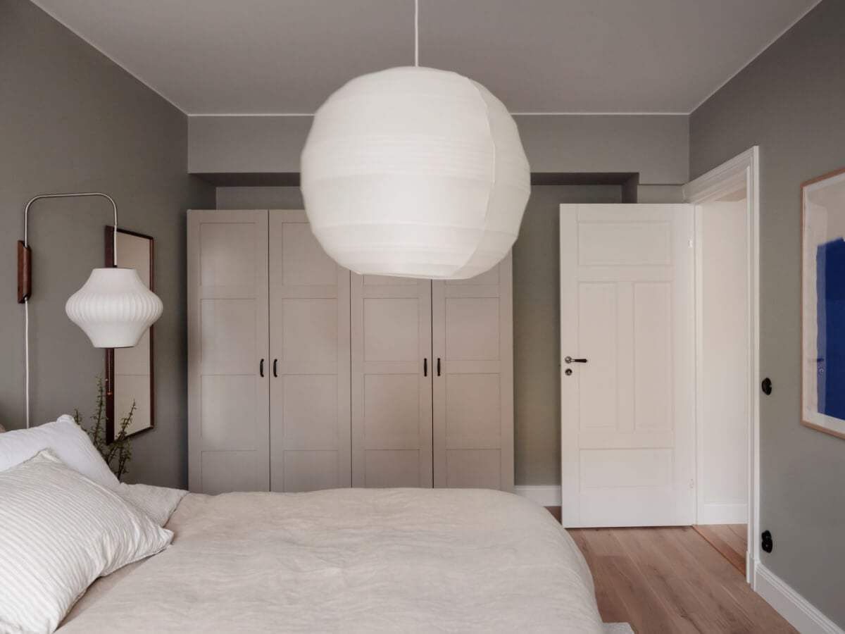 A Calm and Contemporary Apartment in a Former Office Space 18 gray bedroom with wardrobes and wall lamp