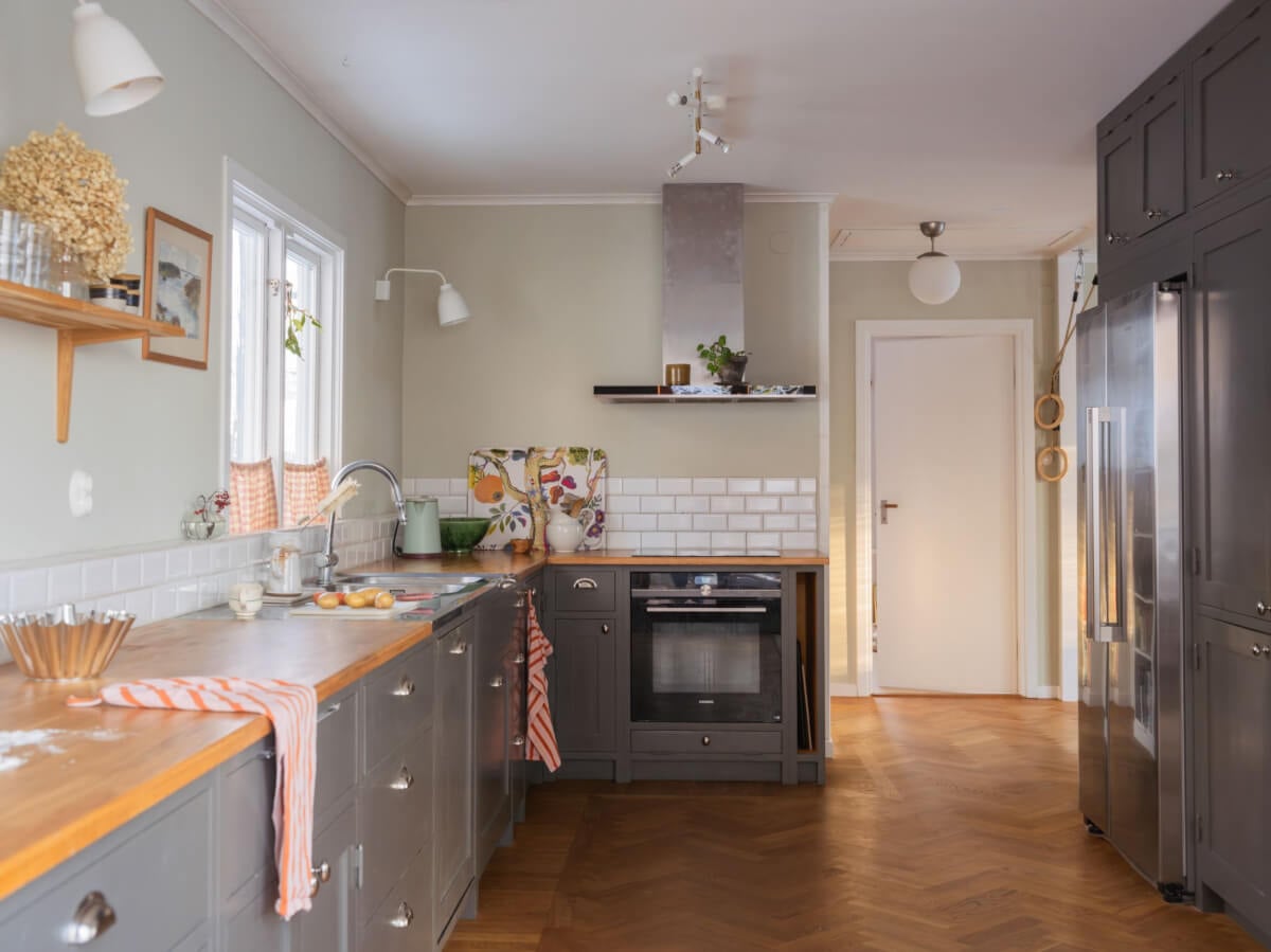 A Beautiful Midcentury Family Home South of Stockholm 4 gray kitchen cabinets and wooden worktop