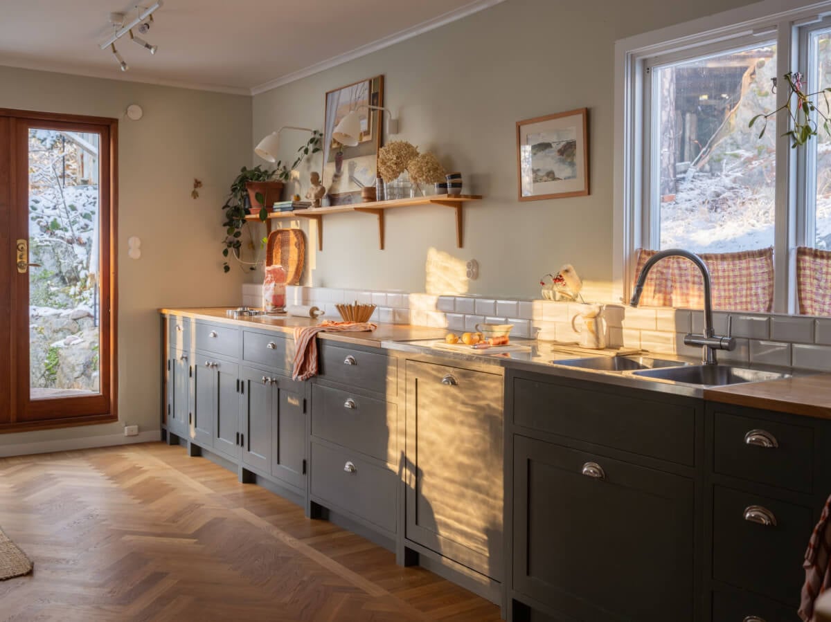 A Beautiful Midcentury Family Home South of Stockholm 3 gray kitchen with warm sunlight flooding in