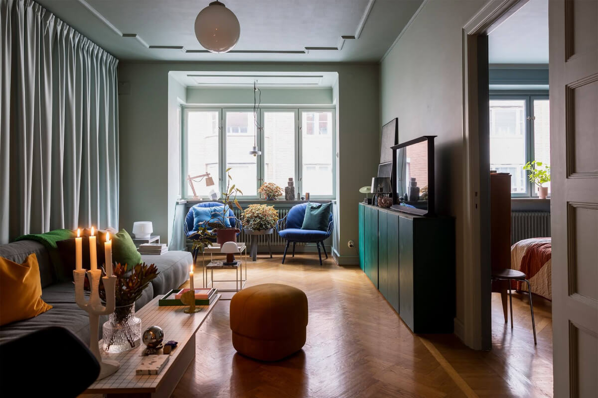 gray living room with bay window and ochre yellow blue and green color accents