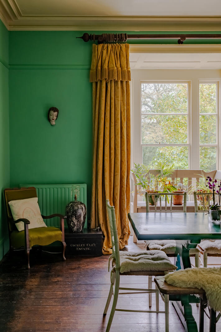 A Strong Color Palette in a Unique Country House in Cornwall 4 green dining room with wooden floor