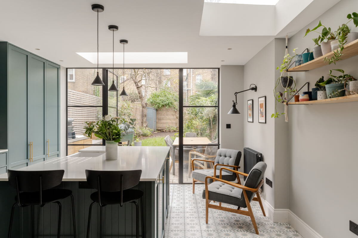 A Beautiful Extended Victorian Family Home in London 6 green kitchen with island and lounge chairs