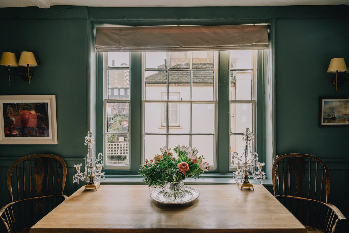 Countryside Charm in a London Apartment in a Former Ale House 5 green living room with wooden table under window