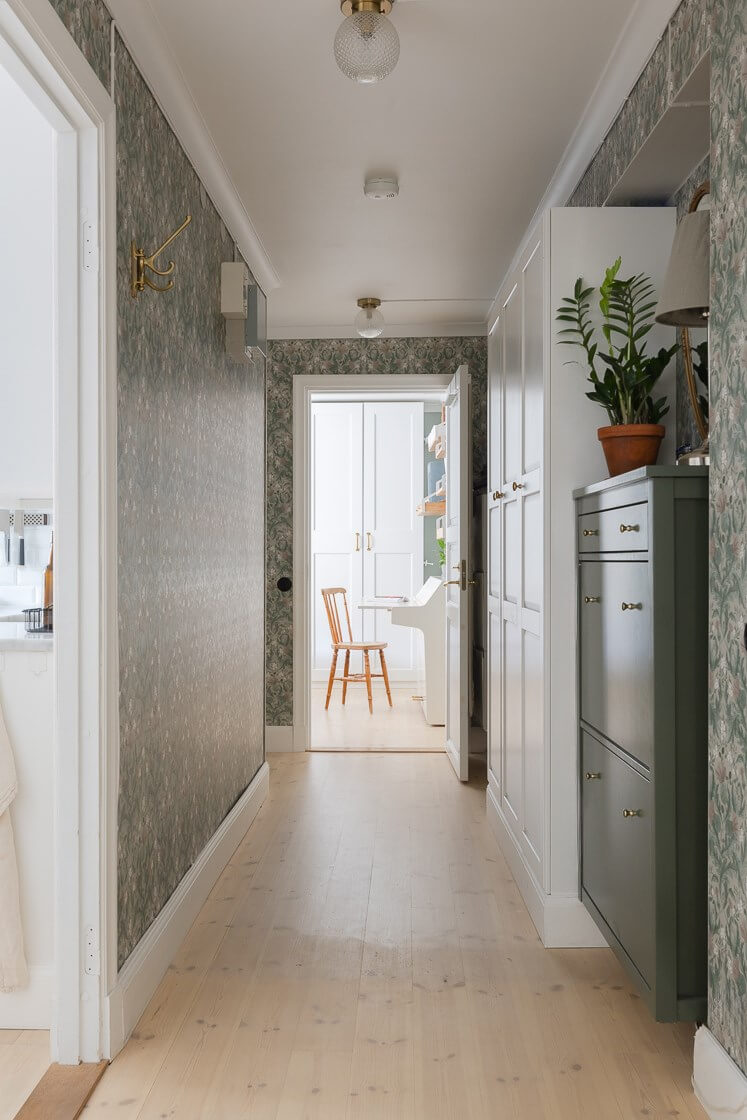 A Small and Bright Two-Bedroom Apartment in Stockholm 23 hall with wallpaper and wardrobes