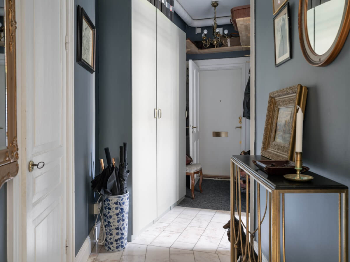 A Classic Studio Apartment with an Industrial Glass Room Divider 15 hallway with wardrobes and shelf above the door nordroom