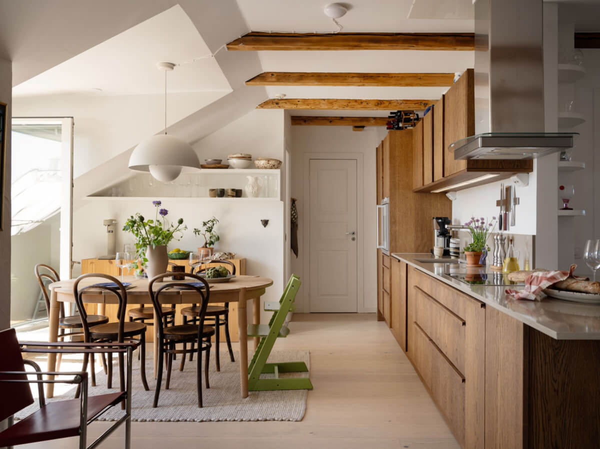 A Charming Light-Filled Attic Apartment with a Dark Oak Kitchen 1 kitchen dining room with exposed beams