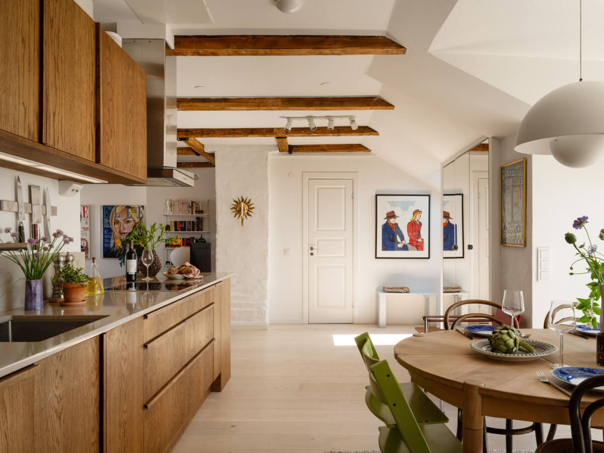 A Charming Light-Filled Attic Apartment with a Dark Oak Kitchen 9 kitchen in an attic apartment with exposed beams