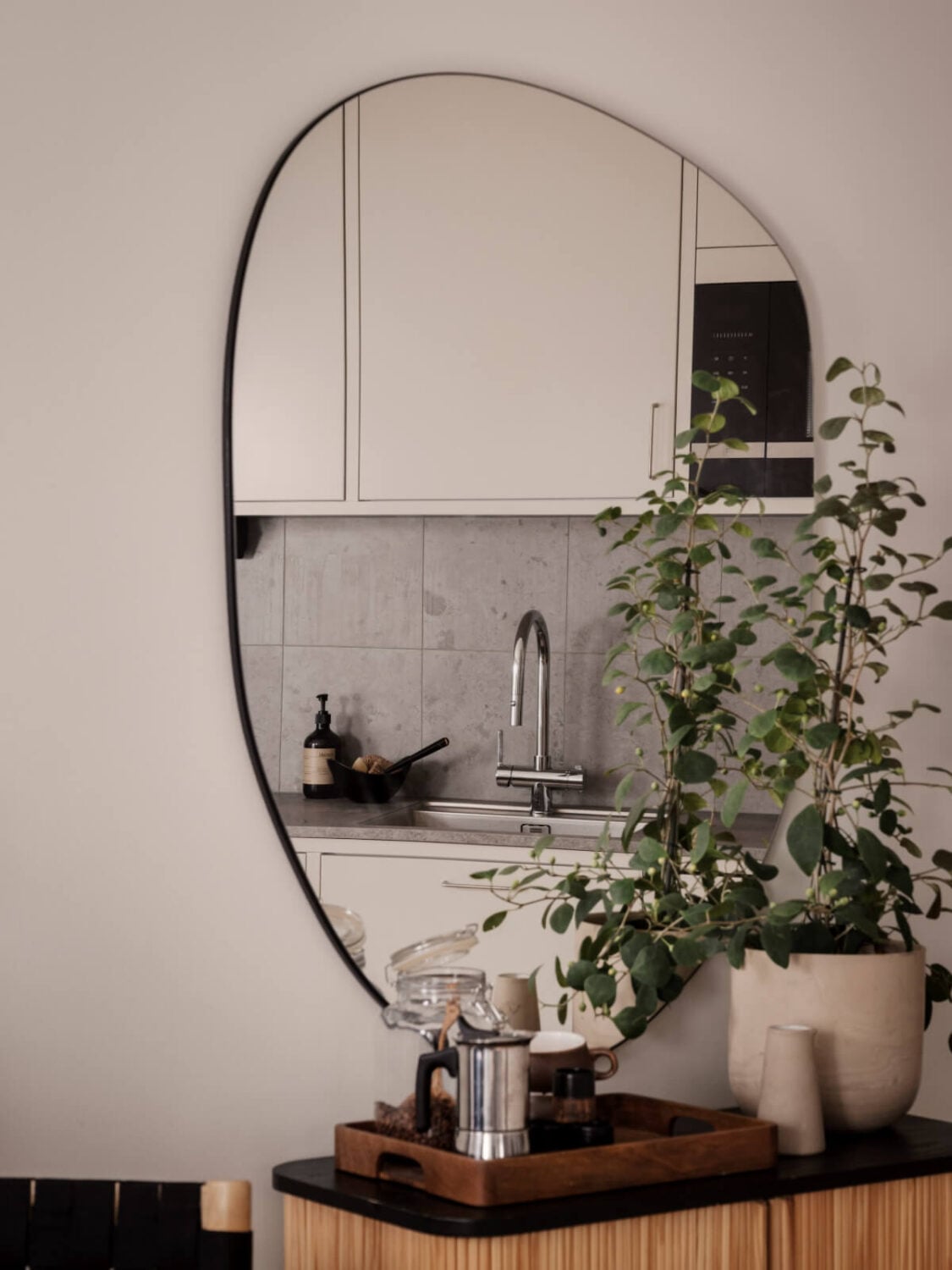 A Calm and Contemporary Apartment in a Former Office Space 11 kitchen mirror