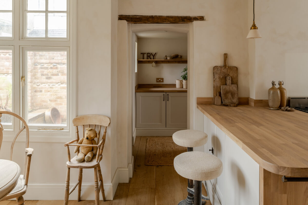 A Light Rustic Farmhouse-Style in an English Cottage 15 kitchen with bar seating and wooden floor nordroom