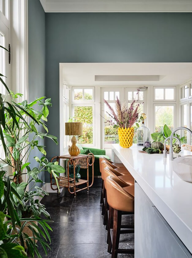 An Amazing Family Home in a Former Dutch Train Station 10 kitchen with island breakfast bar seating and plants