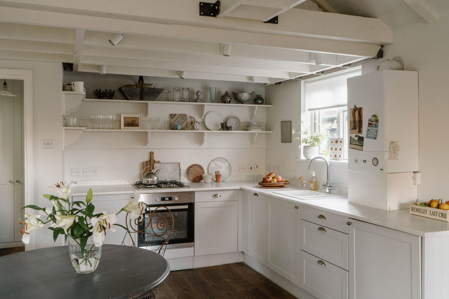 French and Midcentury Influences in a Charming London Studio Apartment 9 kitchen with open shelves