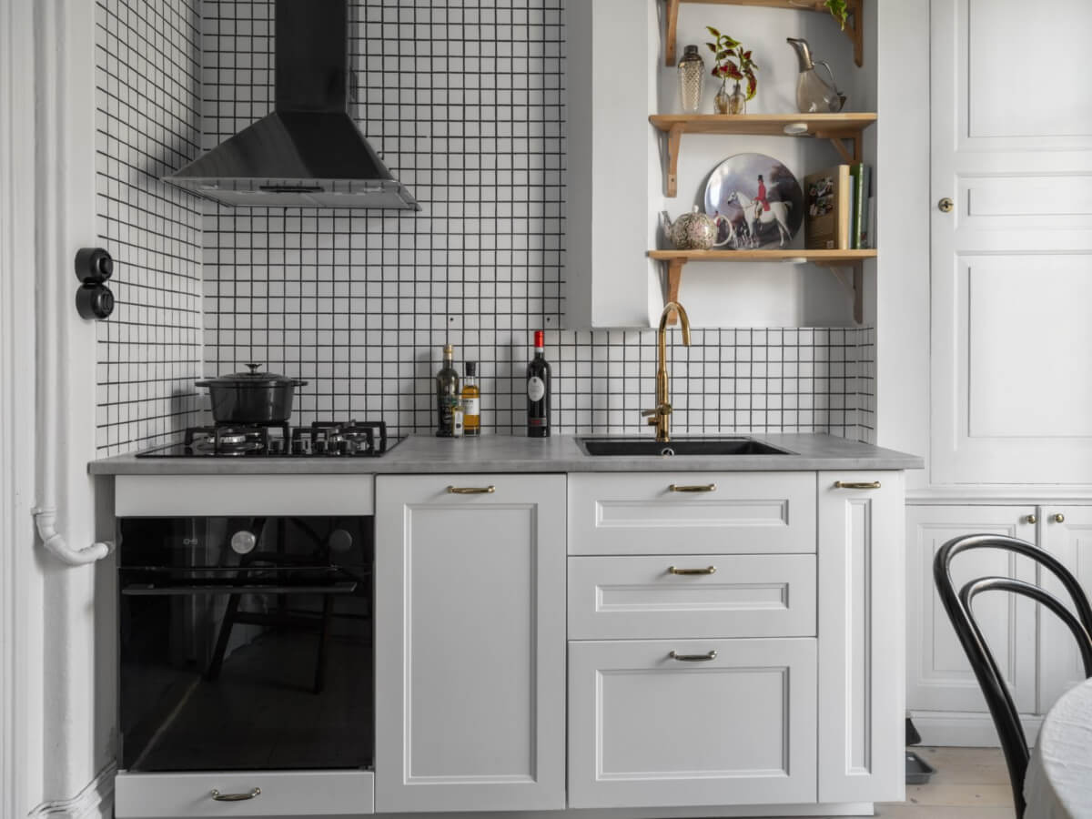 A Classic Studio Apartment with an Industrial Glass Room Divider 12 kitchen with small white backsplash tiles