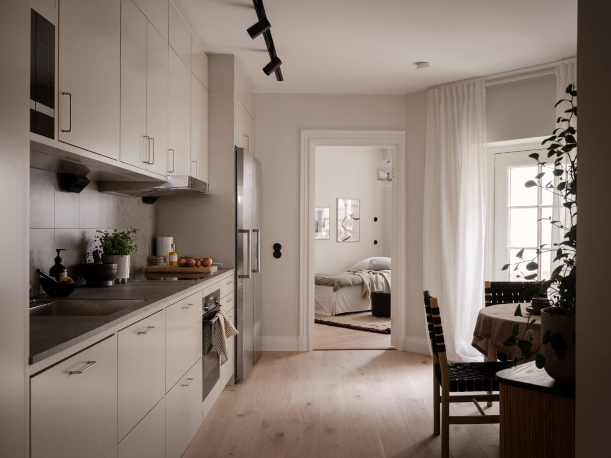 A Calm and Contemporary Apartment in a Former Office Space 12 light gray ktichen with round table