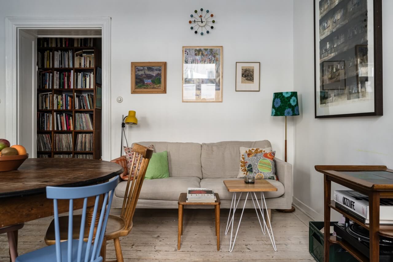 Muted Tones, Art, and Books in a Charming Stockholm Apartment 3 living room with bookcases in the hall