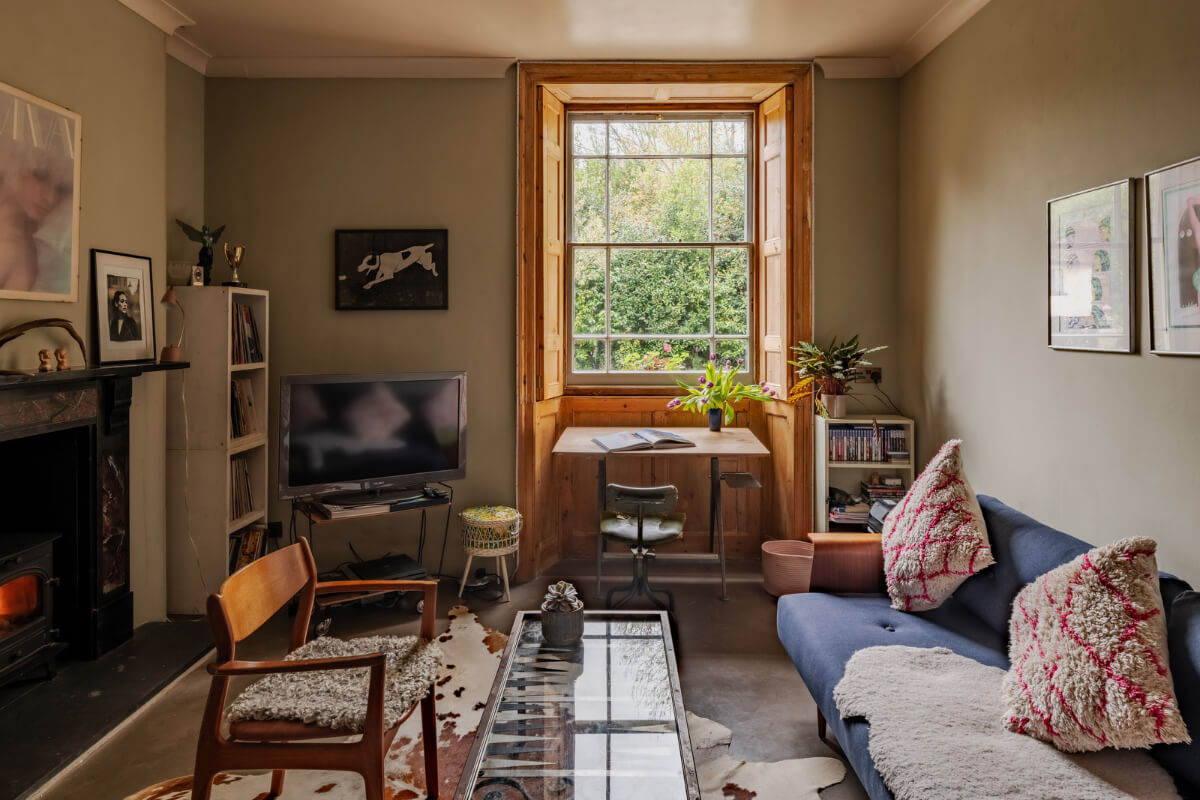 A Strong Color Palette in a Unique Country House in Cornwall 7 living room with desk under window
