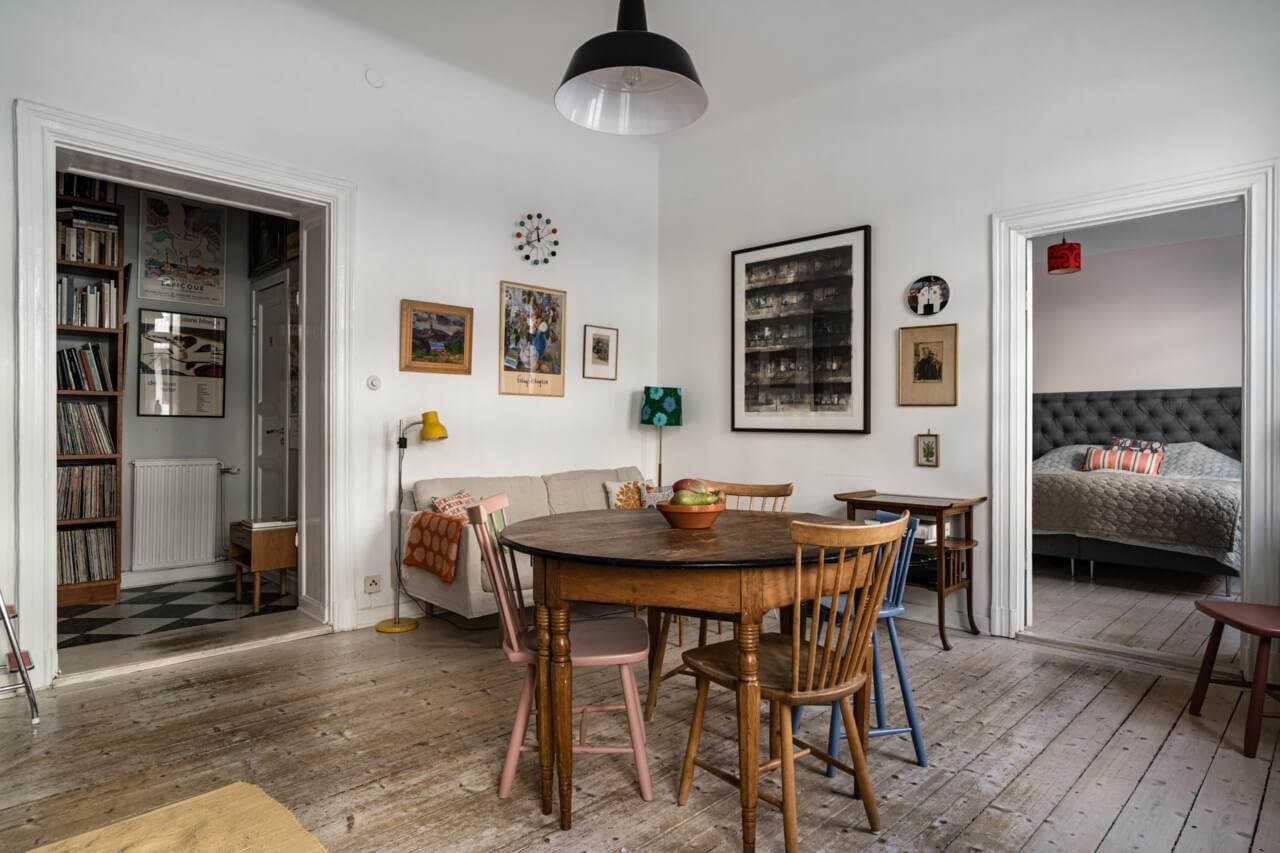 Muted Tones, Art, and Books in a Charming Stockholm Apartment 2 living room with raw wooden floorboards