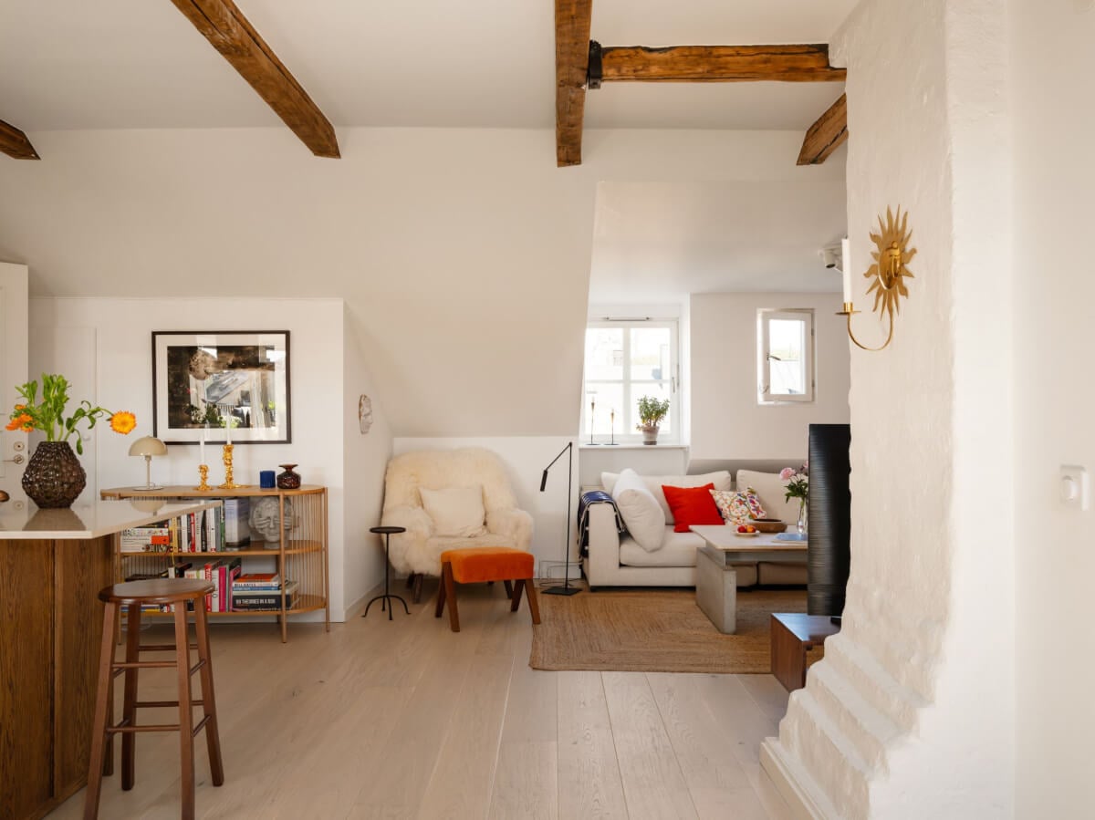 A Charming Light-Filled Attic Apartment with a Dark Oak Kitchen 14 living room with slanted ceiling