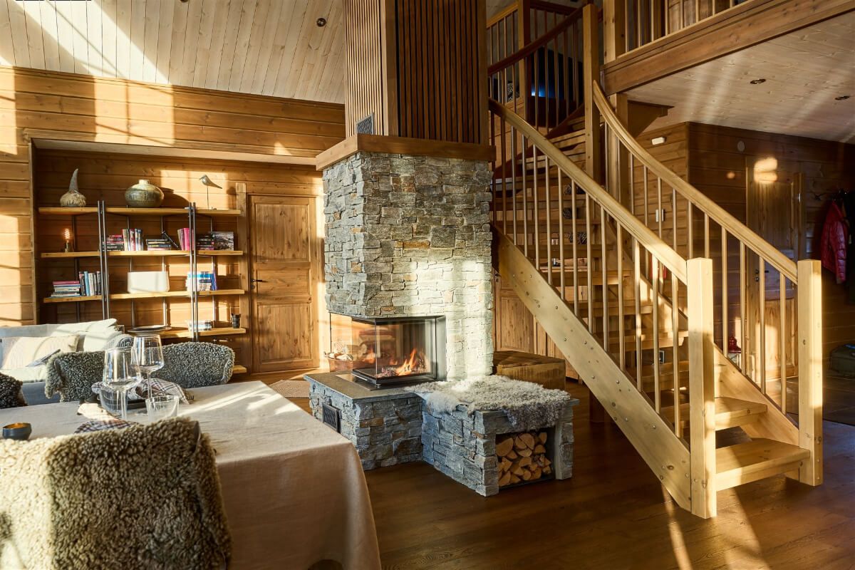 A Warm and Inviting Mountain House in Sweden 6 log house living room with stone fireplace A Warm and Inviting Mountain House in Sweden