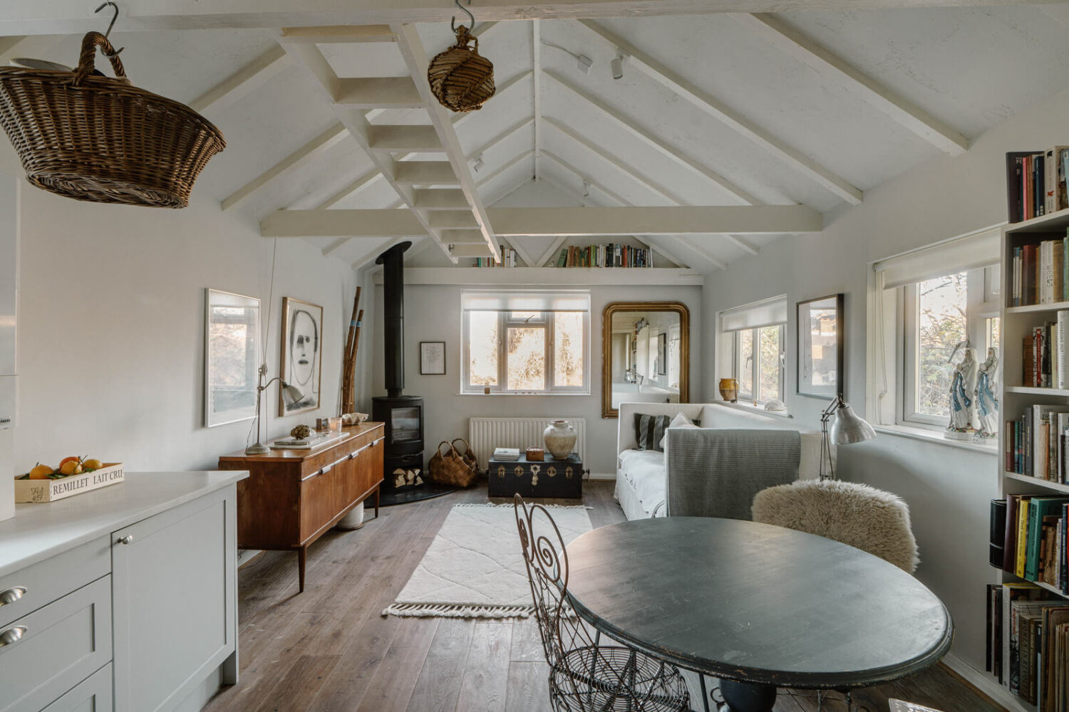 French and Midcentury Influences in a Charming London Studio Apartment 7 london studio apartment with pitched roof and loft bed