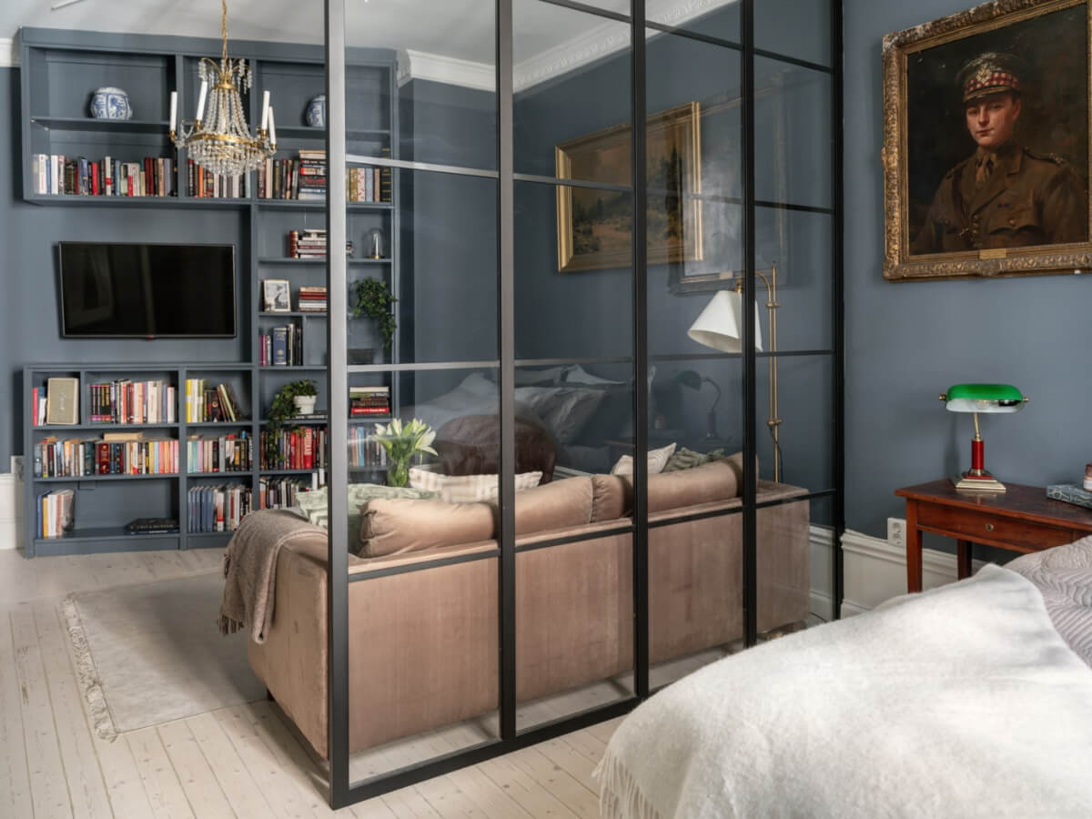 A Classic Studio Apartment with an Industrial Glass Room Divider 9 moody classic studio apartment with glass wall divider nordroom