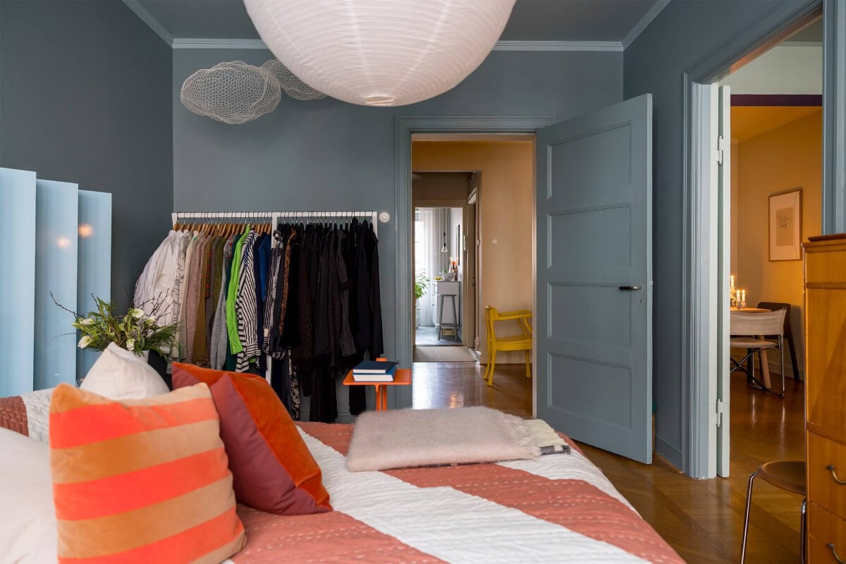 An Interior Designer's Moody Apartment with Period Features 15 moody gray bedroom with clothing rack