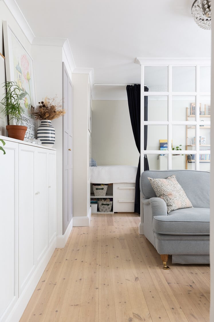 A Small and Bright Two-Bedroom Apartment in Stockholm 6 open living room with room divider and kids bedroom