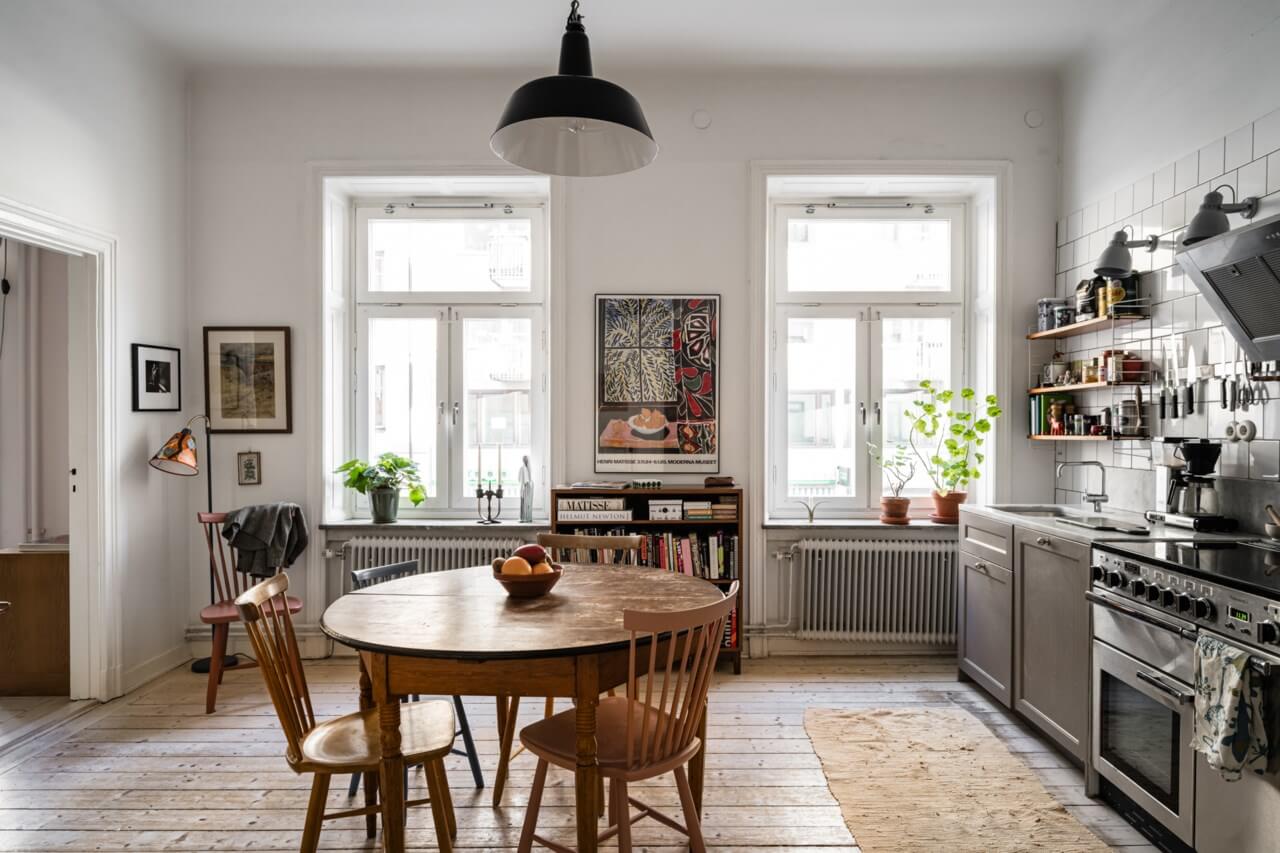 Muted Tones, Art, and Books in a Charming Stockholm Apartment 5 open plan kitchen and living room