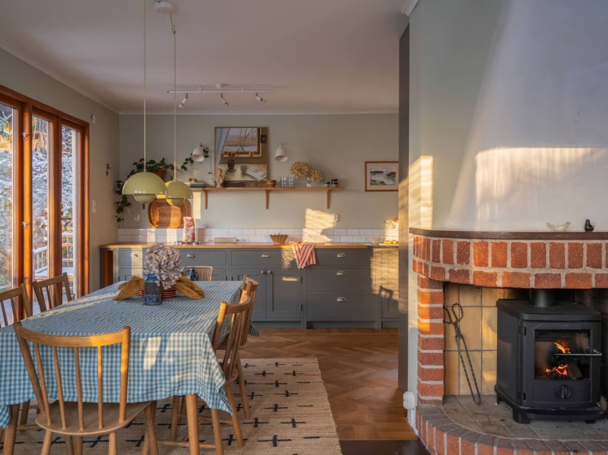 A Beautiful Midcentury Family Home South of Stockholm 1 open plan living space with brick fireplace and dining table