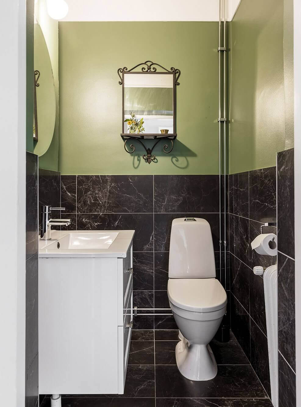 A Spacious Nordic Apartment with a Wonderful Color Palette 21 powder room with green walls and black tiles