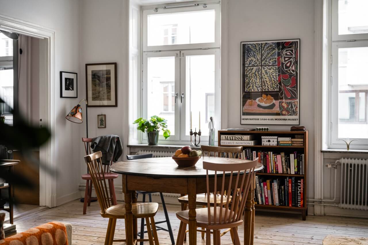 Muted Tones, Art, and Books in a Charming Stockholm Apartment 4 round wooden dining table