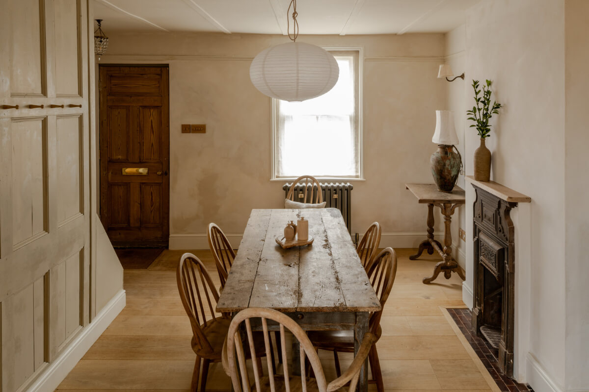 A Light Rustic Farmhouse-Style in an English Cottage 7 rustic wooden dining table and fireplace