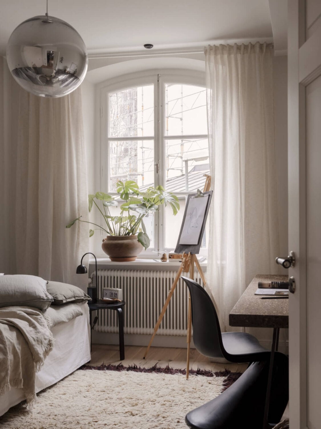 A Calm and Contemporary Apartment in a Former Office Space 20 scandi bedroom with arched window and cork desk nordroom